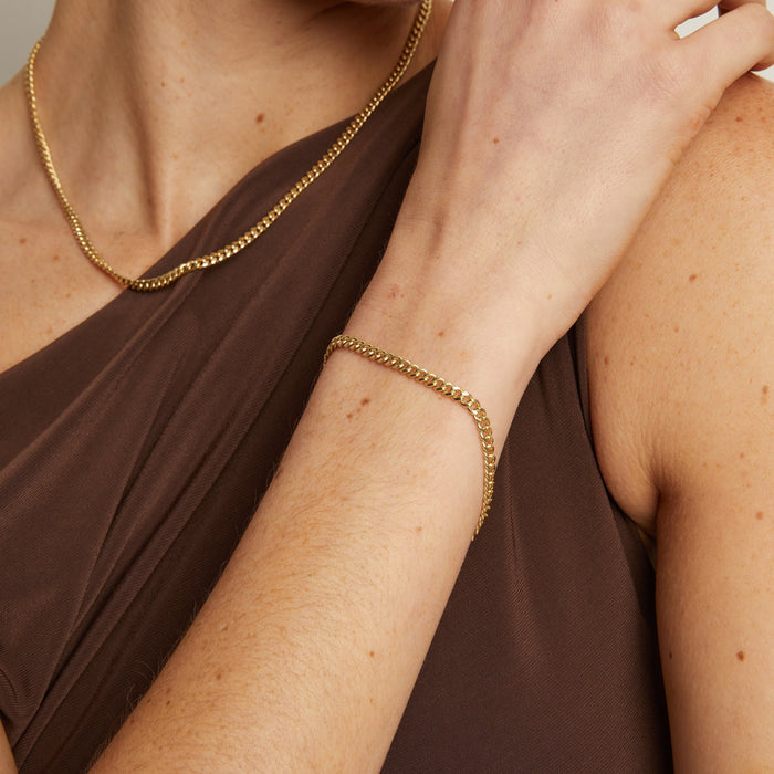 Model. Close up of woman wearing gold bracelet
