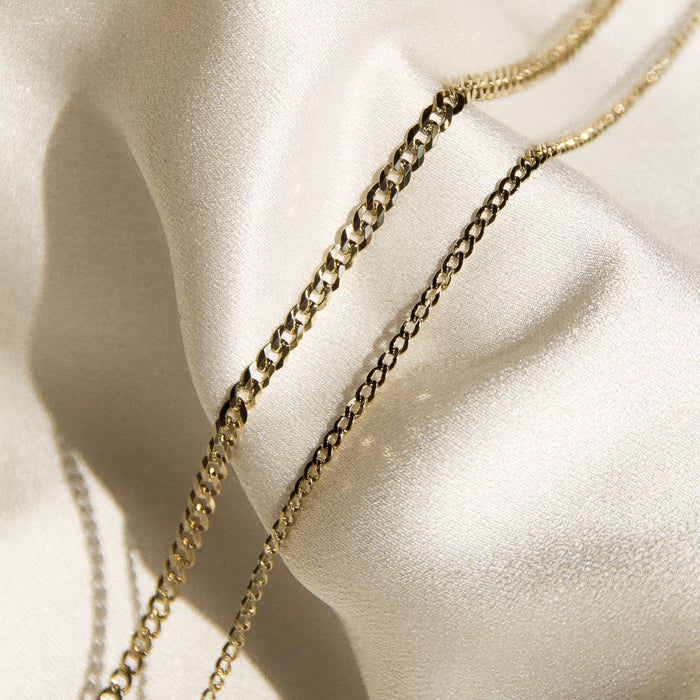Flatlay Model. Close up of two chain necklaces on neutral background