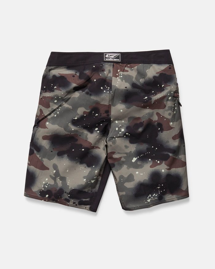 The Volcom Men's Fomenter Mod board shorts feature a camouflage pattern in black, brown, and gray with paint splatter details, a black waistband, and are made from 4-way stretch Stone Shield fabric, shown flat on a white background.