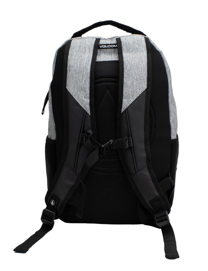 A back view of the Volcom Men's Grindstone Skate Backpack in gray and black, displaying padded shoulder straps, adjustable straps, a top handle, side mesh pockets, a padded laptop sleeve, and an adjustable chest strap against a white background.