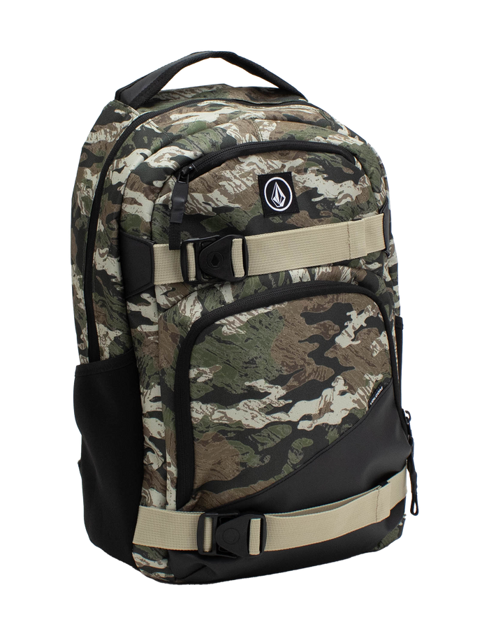The Volcom Men's Grindstone Skate Backpack features a camo pattern with beige adjustable straps, a black bottom, multiple compartments, a dedicated laptop sleeve, and a front logo patch, shown against a white background.