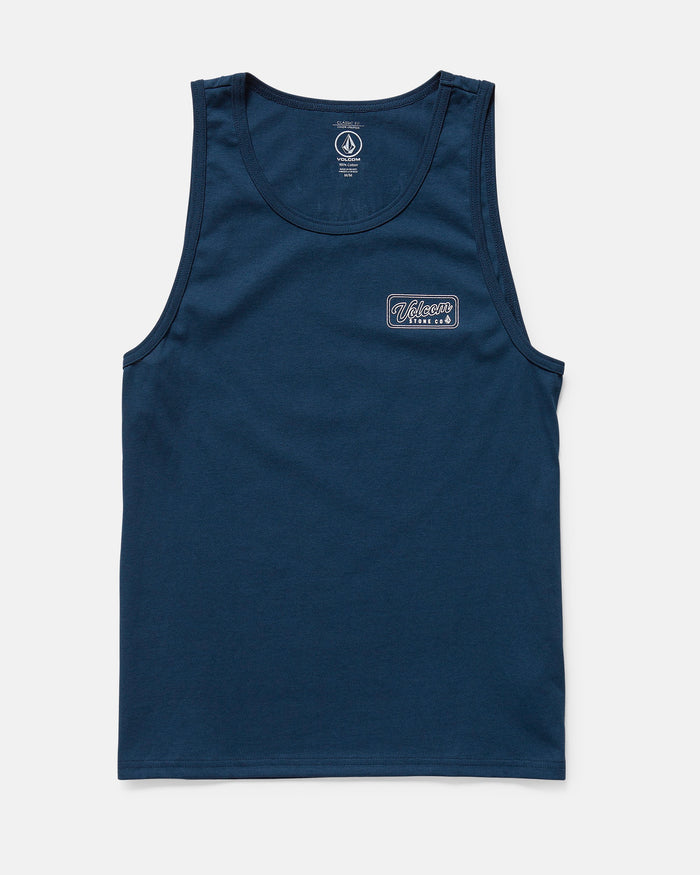 The Volcom Men's Wrecking Tank is a navy blue, sleeveless, classic-fit shirt made of 100% cotton. It has a small rectangular patch with white and blue text on the left chest and is shown laid flat on a white background.