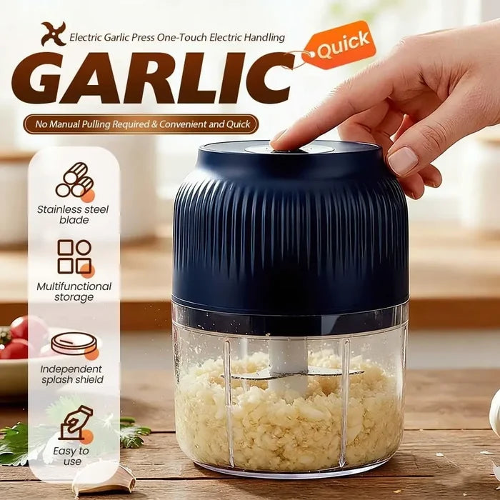 Electric garlic press with a hand using it, displaying minced garlic inside, on a wooden surface.