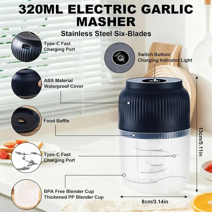 An electric garlic masher with stainless steel six blades, shown with callout labels and dimension markings on a kitchen countertop background. The product has a dark navy ribbed top section and a clear lower cup.