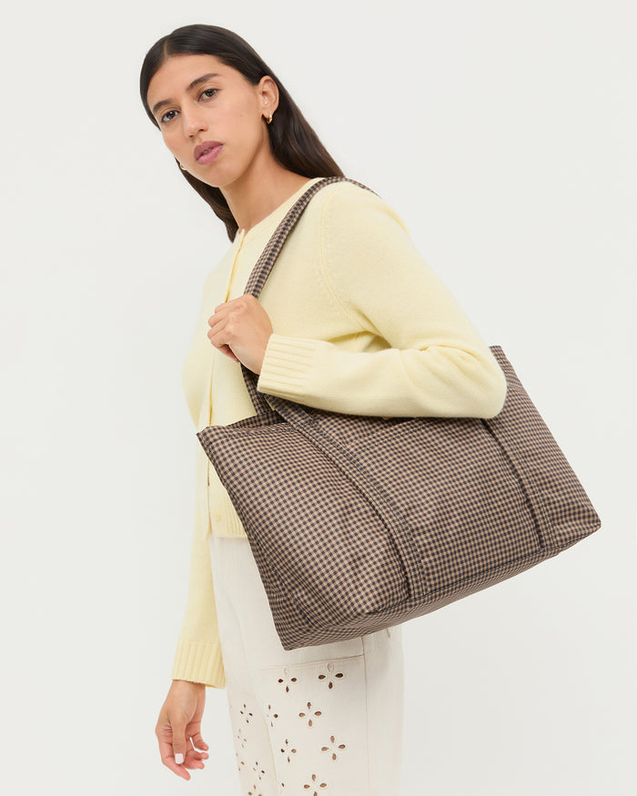 Mira Brown/Black Check Everyday Tote in brown and black check water resistant nylon, Tucker Cardigan in butter yellow cashmere, and Demi Embroidered Pant in natural cotton.