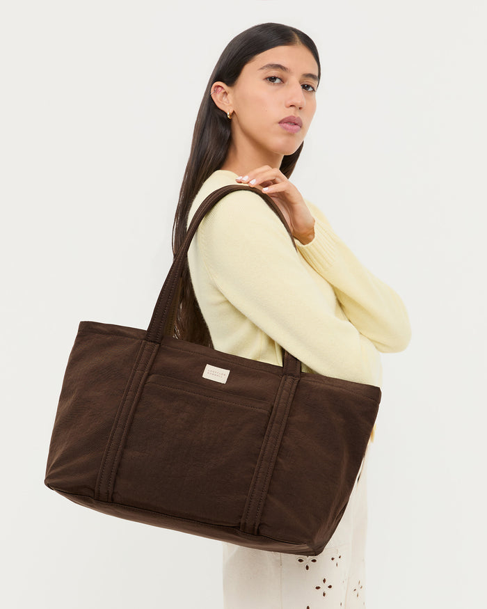 Mira Chocolate Everyday Tote in chocolate brown water-resistant nylon, Tucker Cardigan in butter cashmere, and Demi Embroidered Pant in natural cotton.