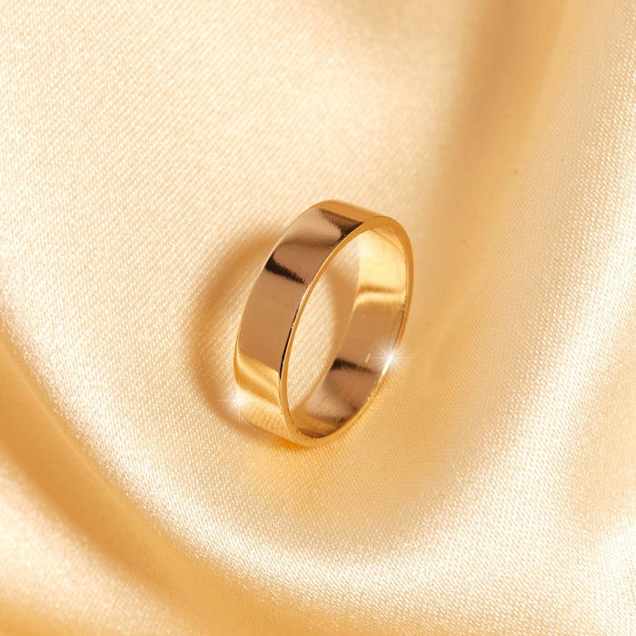 Flatlay Model. Gold ring on yellow background