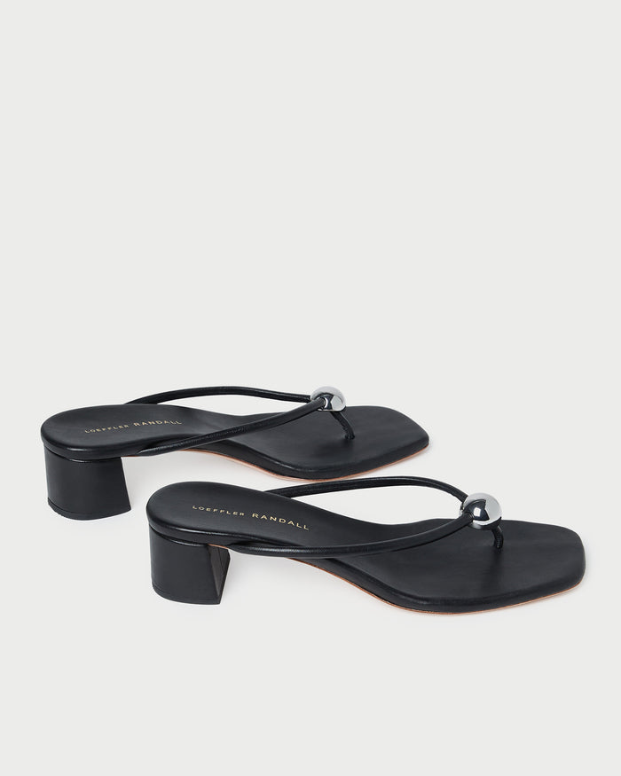 Odessa Black Leather Heeled Sandal in black leather with a silver ball accent.