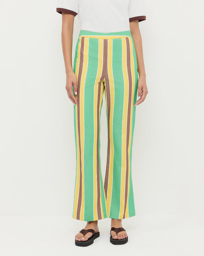 Pasha Trouser in green/yellow/brown striped cotton-linen, Harly Tee in white cotton, and Chase Brown Flip Flop.