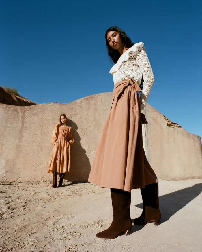 Peyton Skirt in light brown cotton, Abigail Top in cream crocheted cotton, and Cleo Brown Suede Mid-Calf Boot.