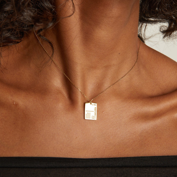 Necklace with a rectangular pendant on a person's neck