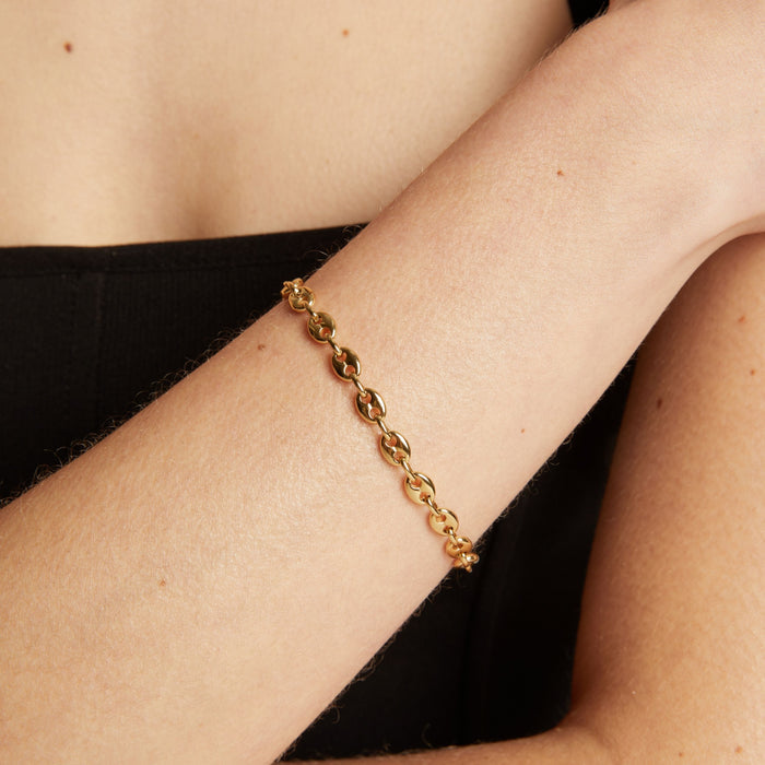 Gold chain bracelet on wrist. Model