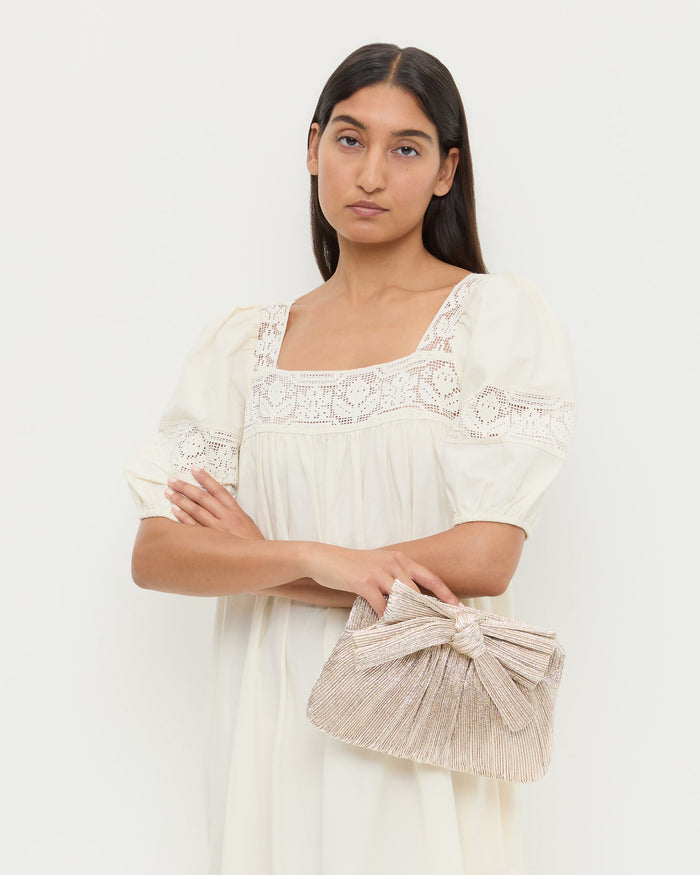 Rayne Champagne Bow Clutch in champagne Italian lamé and Jo Dress.