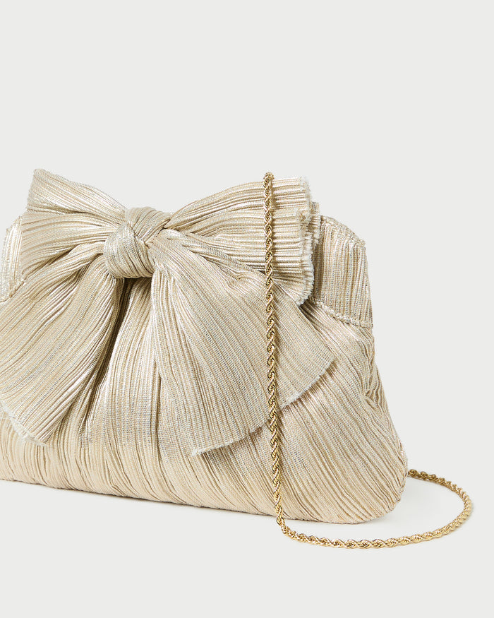 Rayne Platinum Bow Clutch in platinum champagne lamé.