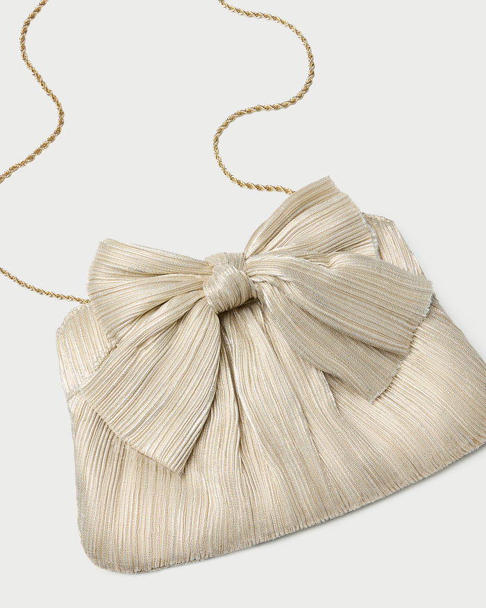 Rayne Platinum Bow Clutch in platinum champagne lamé.