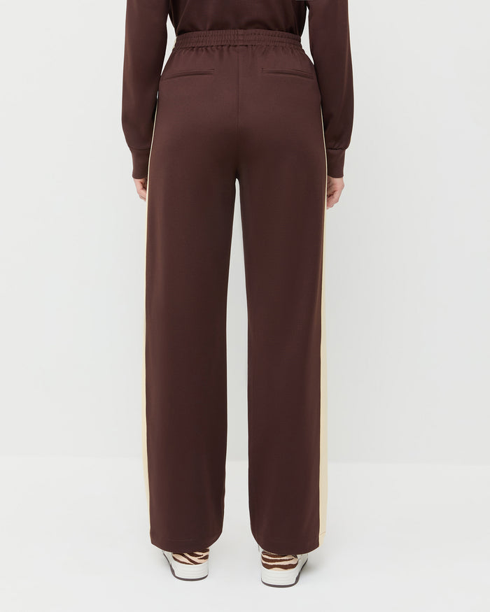 Spencer Sweatpant in dark brown and butter jersey, Emerson Soccer Jersey in dark brown and butter jersey, and Topspin Cream/Zebra Court Sneaker.