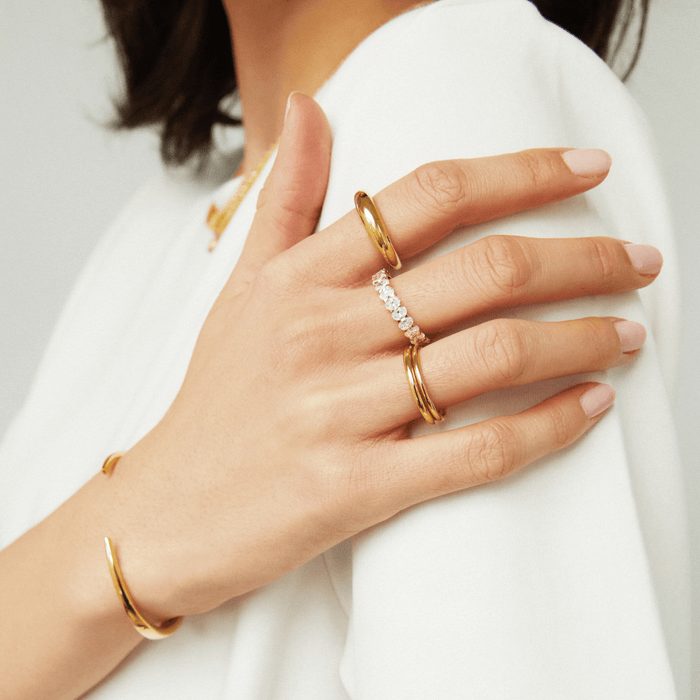 Lifestyle Model close up of woman wearing multiple rings and a gold bracelet