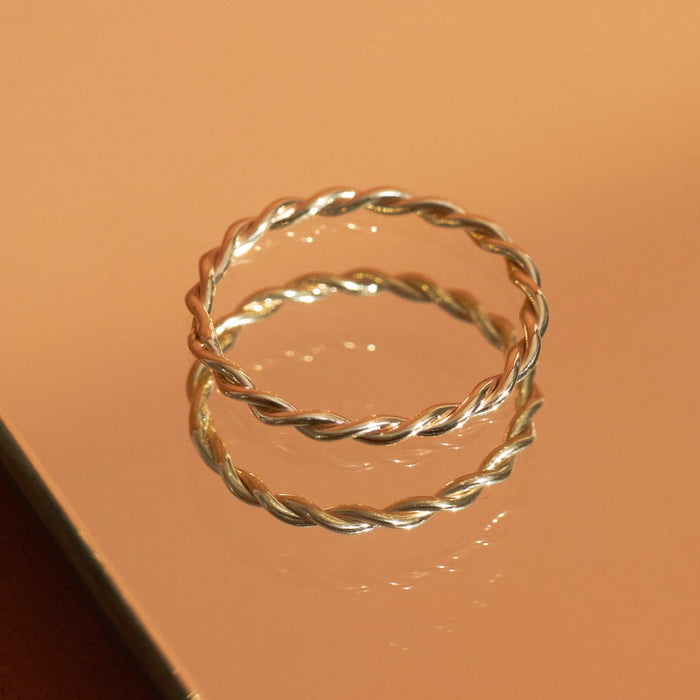 Flatlay Model. A close-up flatlay shot of two stacked gold rings.