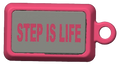 A pink rectangular keychain or tag with a gray front panel and the words 'STEP IS LIFE' printed in pink, shown on a plain white background.