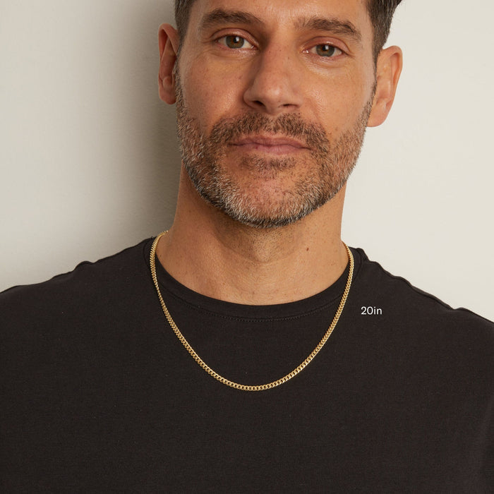 Model Man wearing a gold chain necklace against a plain background