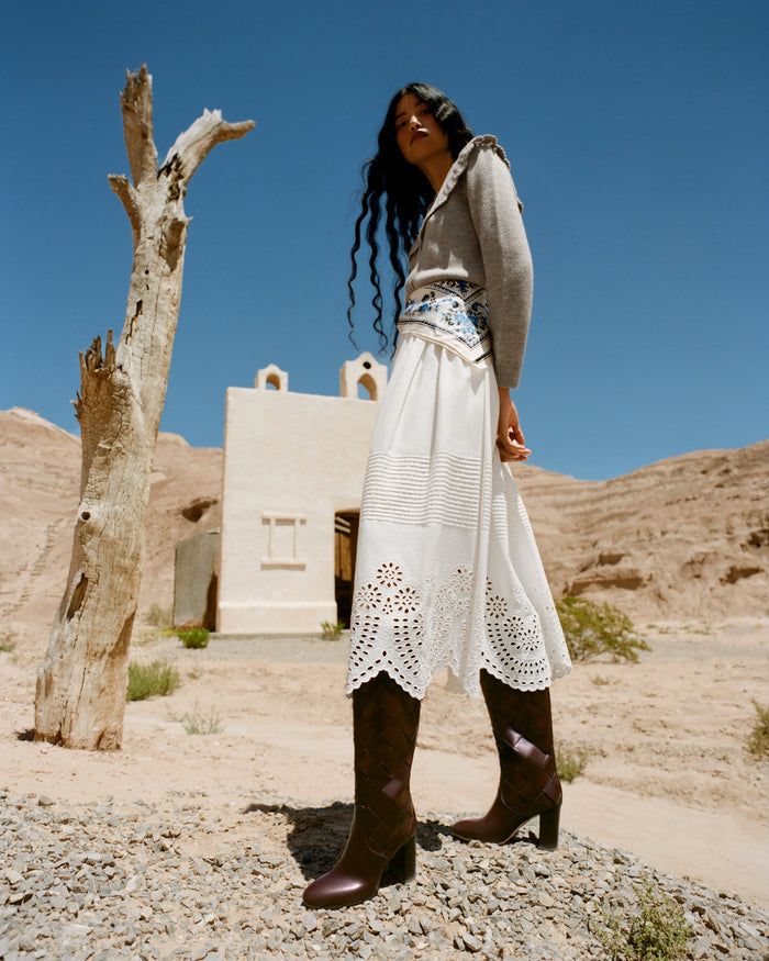 Tinsley Broderie Skirt in cream cotton, Wynn Cardigan in grey wool, and Goldy Espresso Woven Leather Tall Boot.