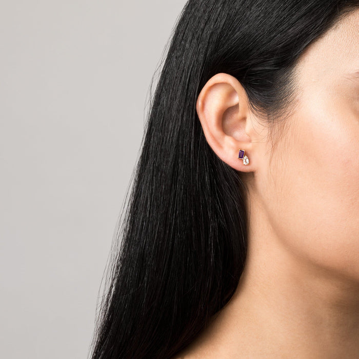 Model. Close up of woman's ear with double gemstone stud earring