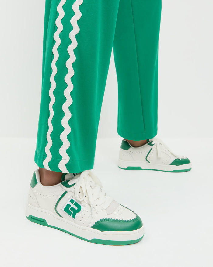 Topspin Cream/Green Court Sneaker in cream and green leather and Venus Track Pant in green cotton.