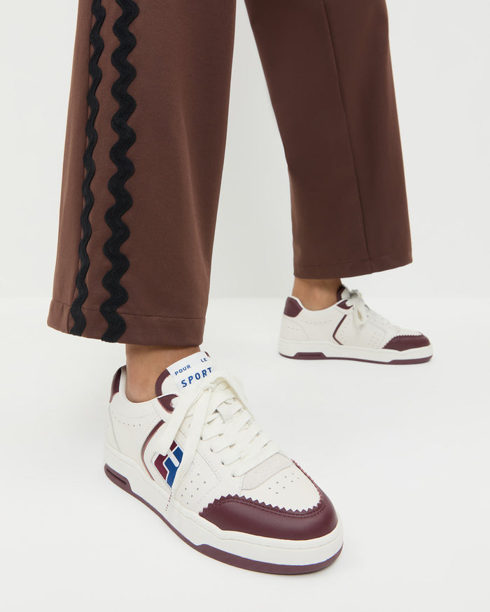 Topspin Cream/Maroon Court Sneaker in cream and maroon leather and Venus Track Pant in maroon cotton.