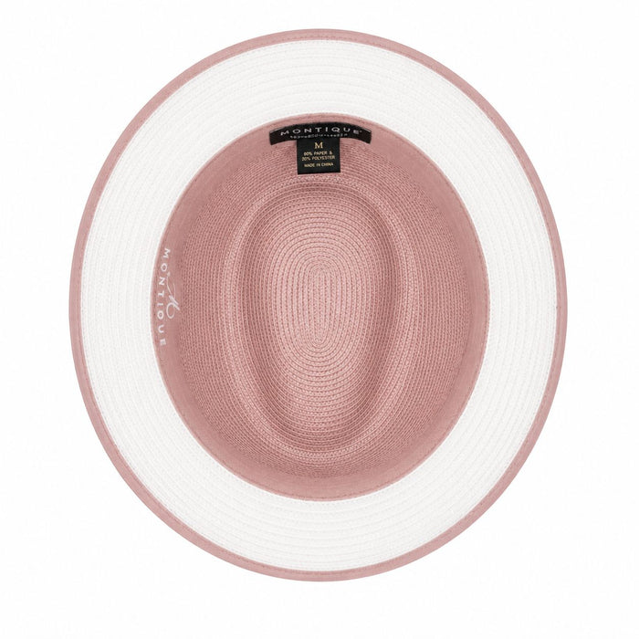 A top-down view of a Montique wide-brimmed hat, featuring a dusty rose pink crown and brim with a contrasting white outer band, set against a plain white background.