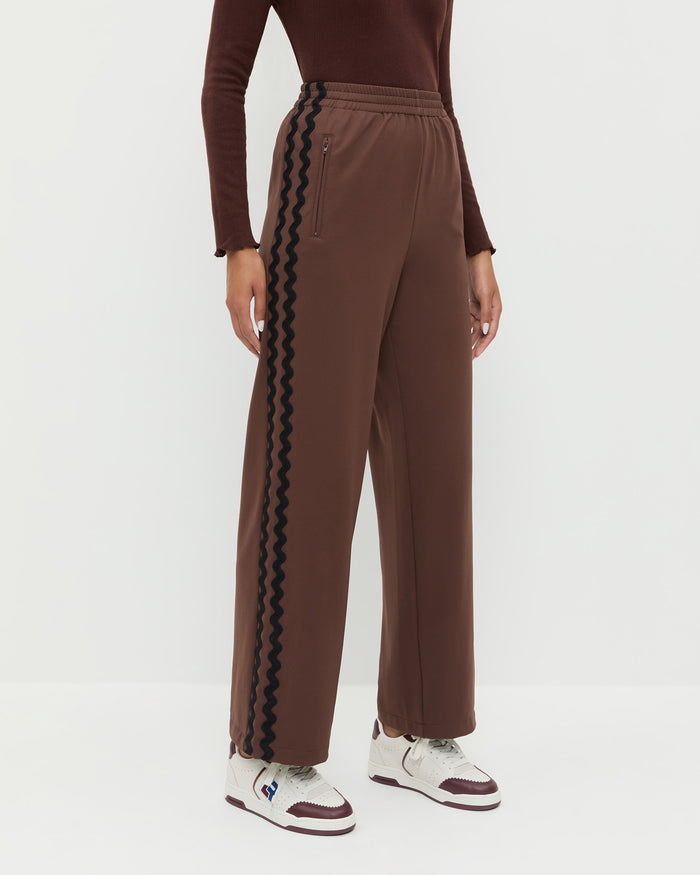 Venus Track Pant in brown nylon, Lolo Pointelle Long-Sleeve Top in espresso brown pointelle, and Topspin Cream/Maroon Court Sneaker.