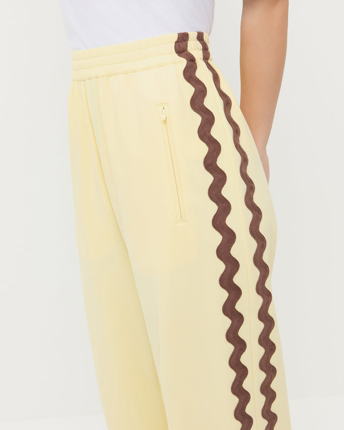 Venus Track Pant in butter yellow nylon, and Harly Tee in white cotton.