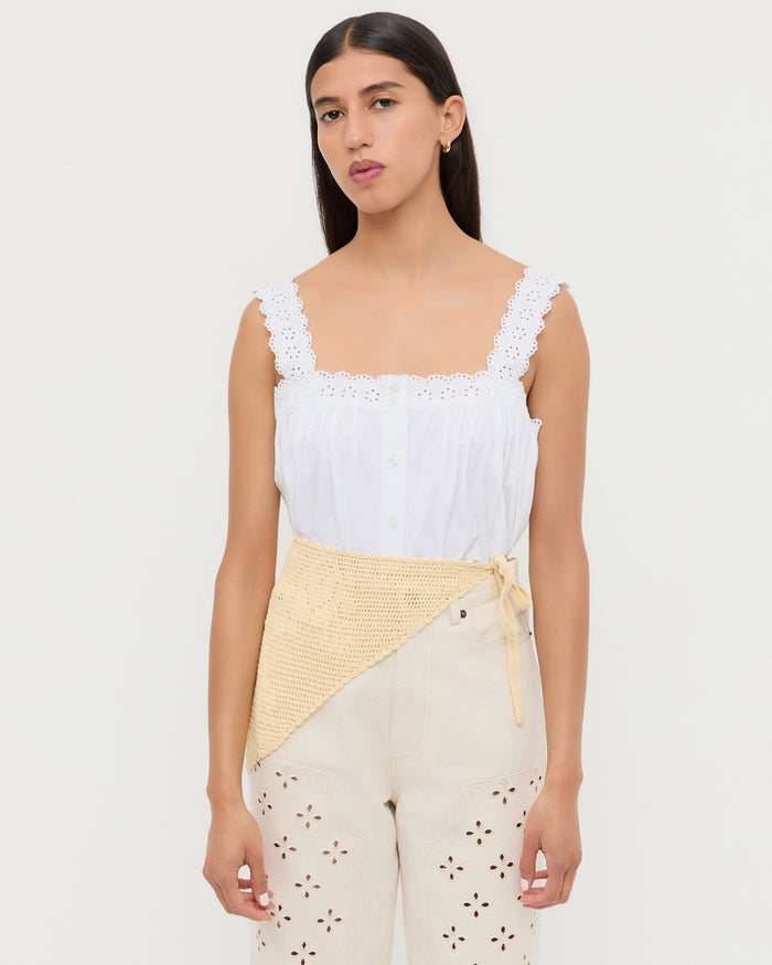 Viv Butter Crochet Scarf in butter yellow crocheted cotton, Emma Top in white cotton, and Demi Embroidered Pant in natural tan cotton.