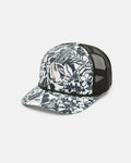 The Volcom Women's Into Paradise Trucker features a black and white design with a floral sublimation print on the front and brim, a circular logo, and classic black mesh back for breathability.
